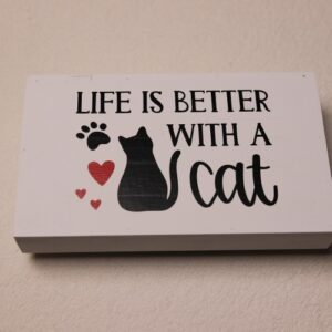 Rectangular box sign featuring a cat, paw print, and red hearts for a splash of color. "Life is better with a cat."
