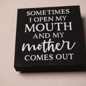 Box sign with "like mother like daughter" type saying. Black paint with fun white lettering.