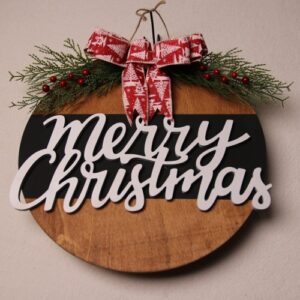 Large wooden sign with dark oak stain and black painted stripe. Features "Merry Christmas" in a fun cursive font made of wooden letters, and adorned with a red and white holiday festive ribbon tied around pine and holly berry.