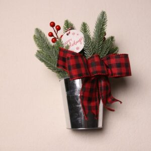Small table-top holiday decoration. Metal pale full of faux pine needles and holly berries. Complete with cute Christmas gift tag reading "HAPPY Holidays" in fun festive font. Red and black checkered ribbon to complete the Christmas Cheer.