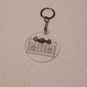 Key chain for the ultimate Softball Mom. Clear circular disc keychain with fun "Softball Mom" text.