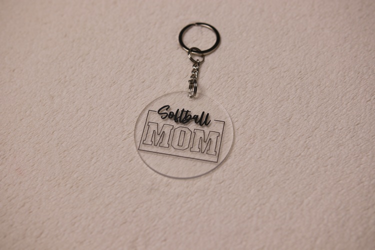Key chain for the ultimate Softball Mom. Clear circular disc keychain with fun "Softball Mom" text.