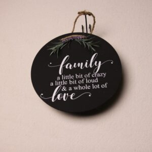 10 inch wooden circular sign. Black paint with whimsical white lettering. Pine needle top and rustic twine hanging cord.