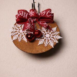 6.5 inch round wooden sign with dark oak stain. Cute and playful large white snowflakes red metallic jingle bells. Complete with a big red bow with white "Merry Christmas" messaging.